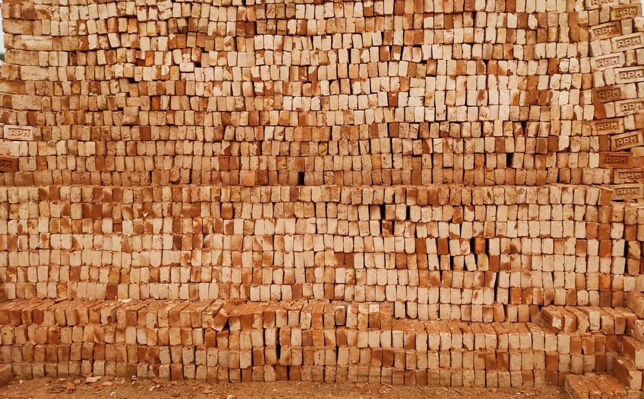 Junge Frau baut an einer LEGO-Vogel-Skulptur im Bricks Hanau Store, umgeben von farbigen Steinen in Regalen